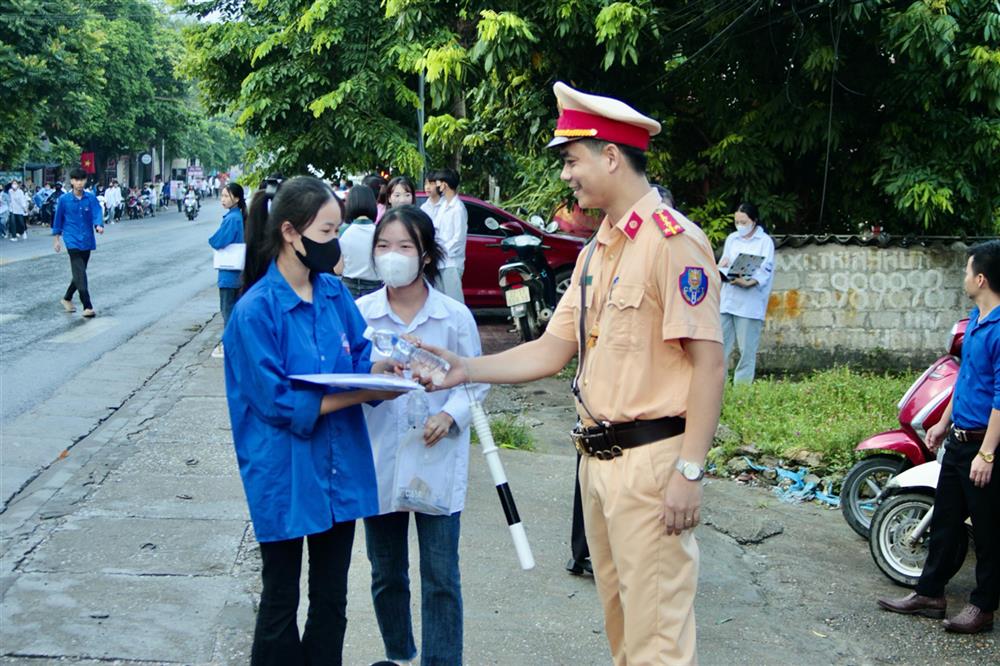 Lực lượng Công an và đoàn viên thanh niên tặng nước uống và đồ ăn nhẹ tiếp sức cho thí sinh trước giờ thi.