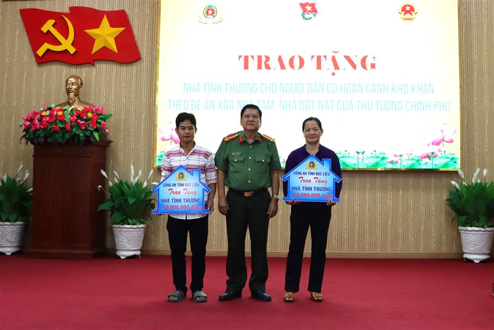 Đại tá Trương Công Dũng, Phó Giám đốc Công an tỉnh trao bảng tượng trưng tặng nhà tình thương cho người dân tại Lễ ra quân Tháng Thanh niên năm 2025.