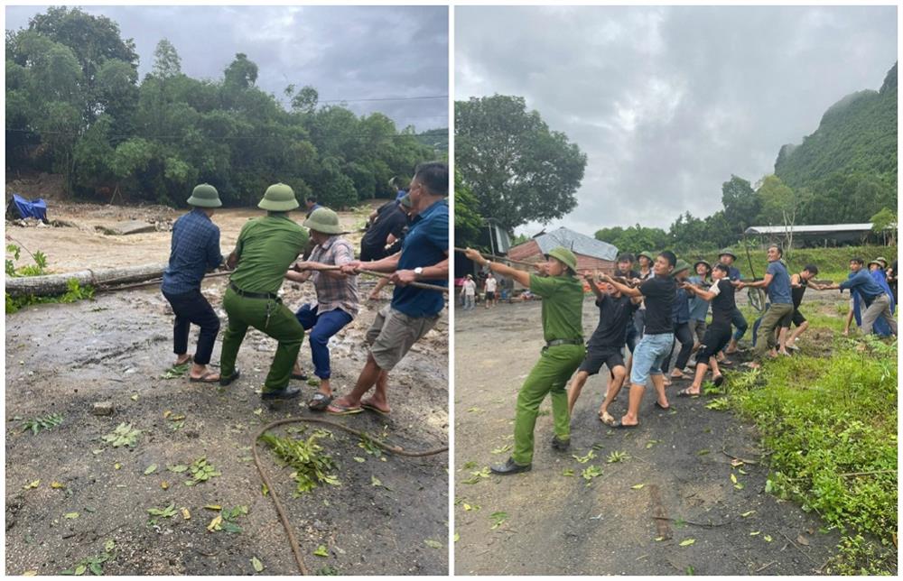 Công an huyện Tân Kỳ cùng người dân chằng néo giữ cầu bị trôi và chặt cây to có nguy cơ gãy đổ làm sập cầu.